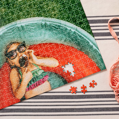 A custom photo puzzle almost fully assembled featuring an image of a child in a swimming pool.